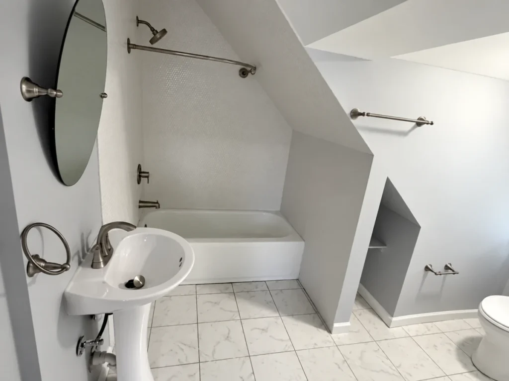Updated bathroom with tiled shower walls and finished fixtures
