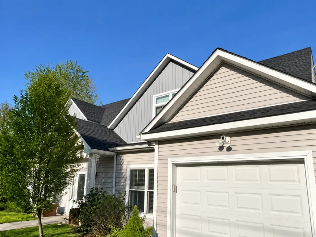 Residential garage exterior with a paved driveway and landscaped grounds